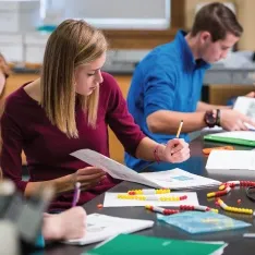 A group of students doing labwork in a biology lab.